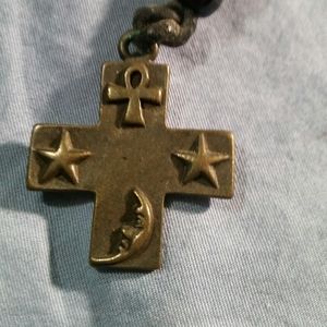 Cross shaped pendant with ankh, moon, and stars
